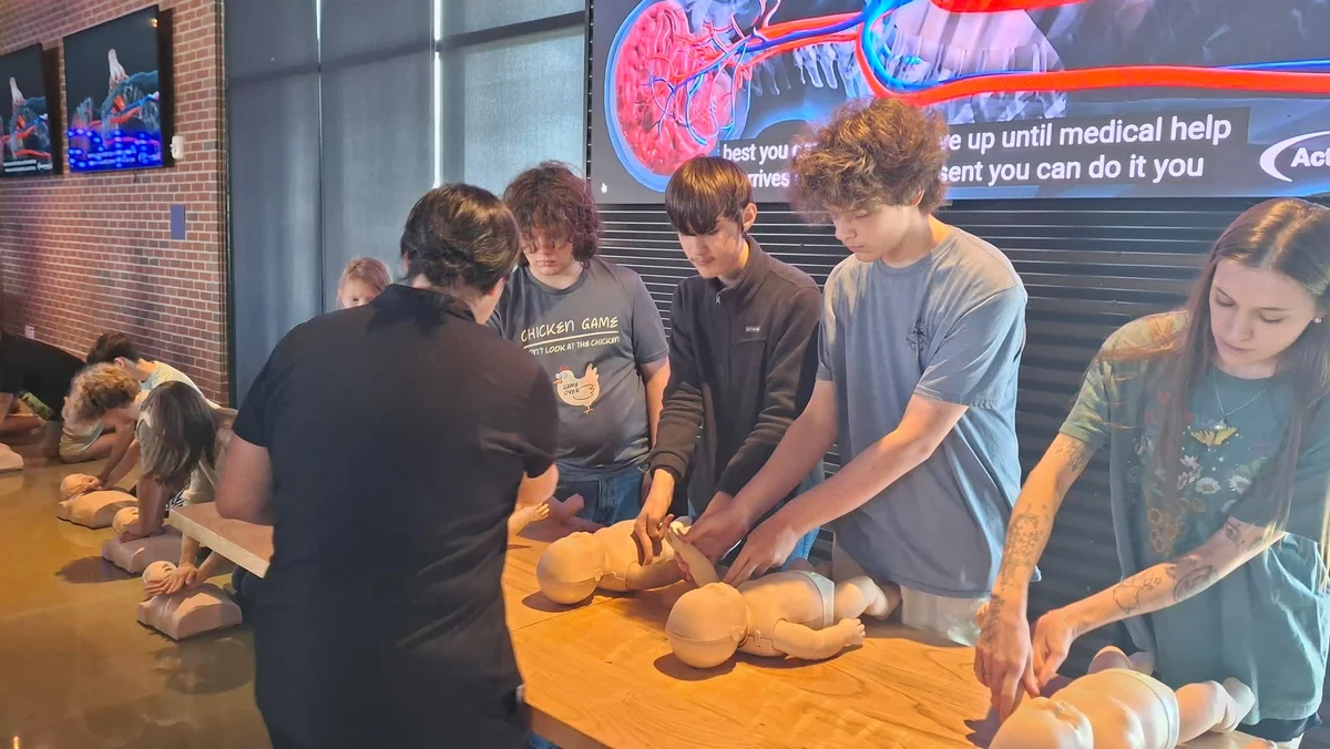 Families learning hands-only CPR at a Fundamentally Awesome safety training event